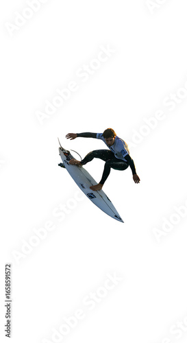 Dynamic surfer catches air executing extreme aerial maneuver on surfboard during competition