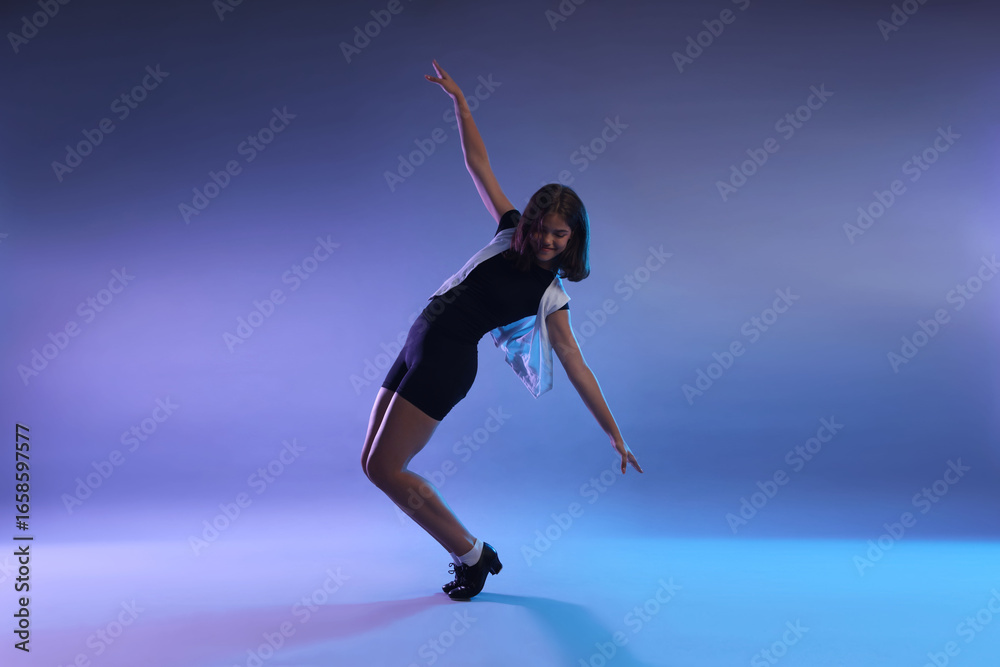 Teenage girl in tap shoes dancing on color background Teenage girl in tap shoes dancing on color background