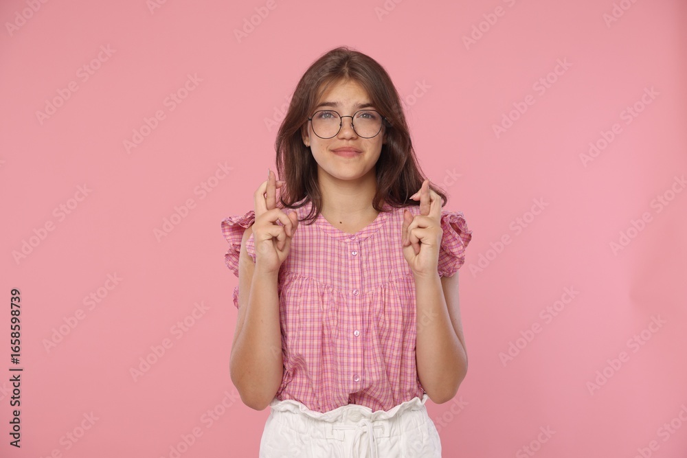 Student crossing fingers on pink background. Hope for good exam result Student crossing fingers on pink background. Hope for good exam result