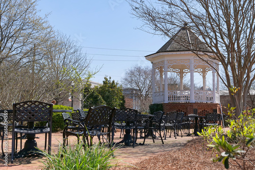 Tranquil scene of a white gazebo and outdoor seating area in Madison Town Park, Georgia, USA