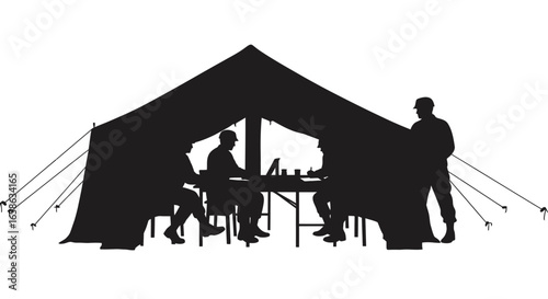 Military Personnel Working Inside Tent Silhouette Soldiers in silhouette are depicted working at a table inside a tent showcasing teamwork