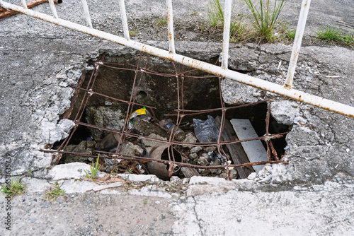 Pothole on Broken Concrete Sidewalk