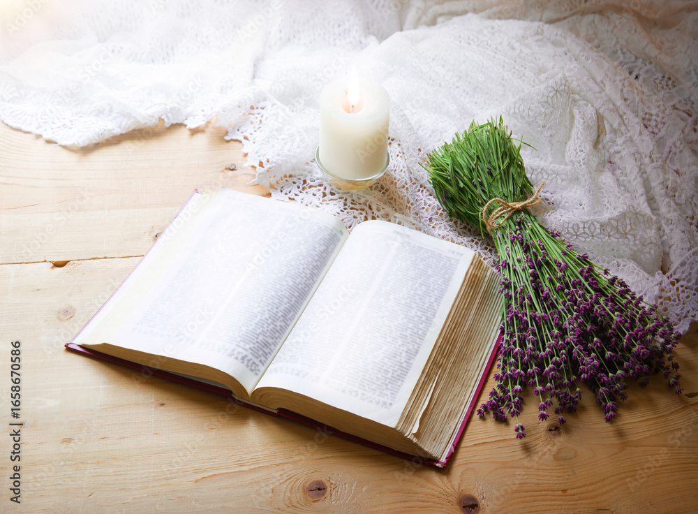 Fototapeta premium A bouquet of lavender near an open bible