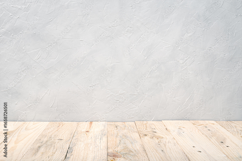 Fototapeta premium Empty wooden deck table over white textured wall background