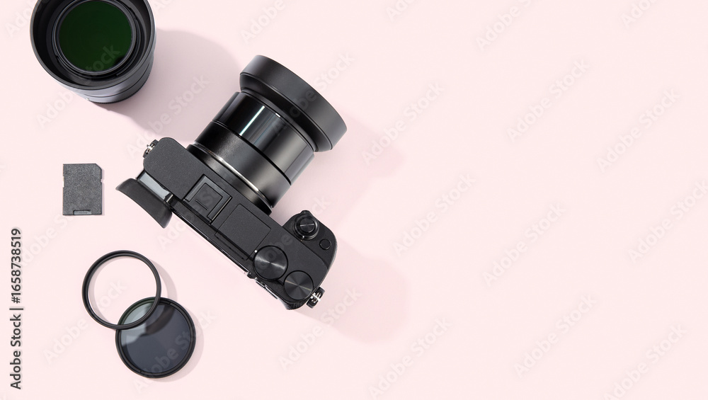 Naklejka premium Flat lay of digital photographic equipment isolated on pink background. Photography concept