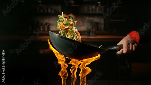 Freeze Motion of Flying Asian Wok Ingredients with Fire Flames