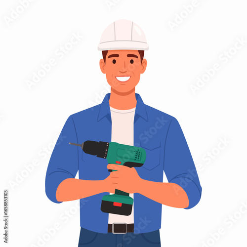Cheerful male construction worker in a blue shirt and white hard hat, holding a green cordless power drill.