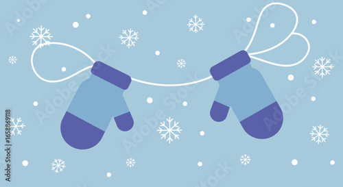 Cozy blue mittens with string and falling snowflakes create a charming winter atmosphere