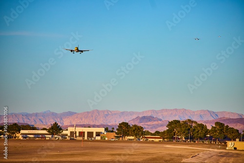 Airplane taxiing at Las Vegas airport Nevada terminal with city skyline in background