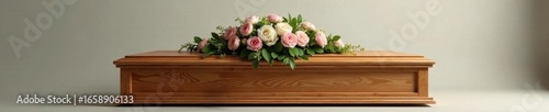 Simple wooden casket, modest floral spray, quiet setting, calm, repose, contemplation