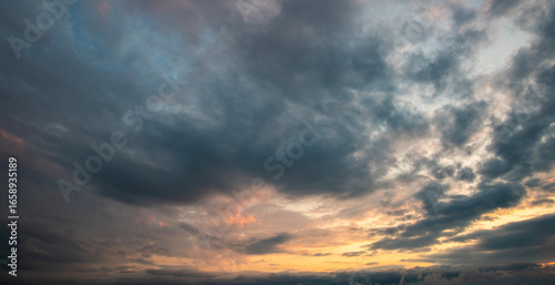Evening sunset sky background with bright dramatic clouds.