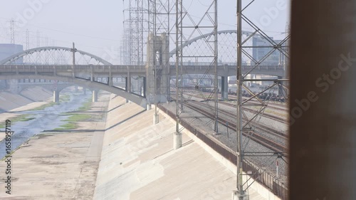 LA River With Train Tracks And Traffic On Bridge.