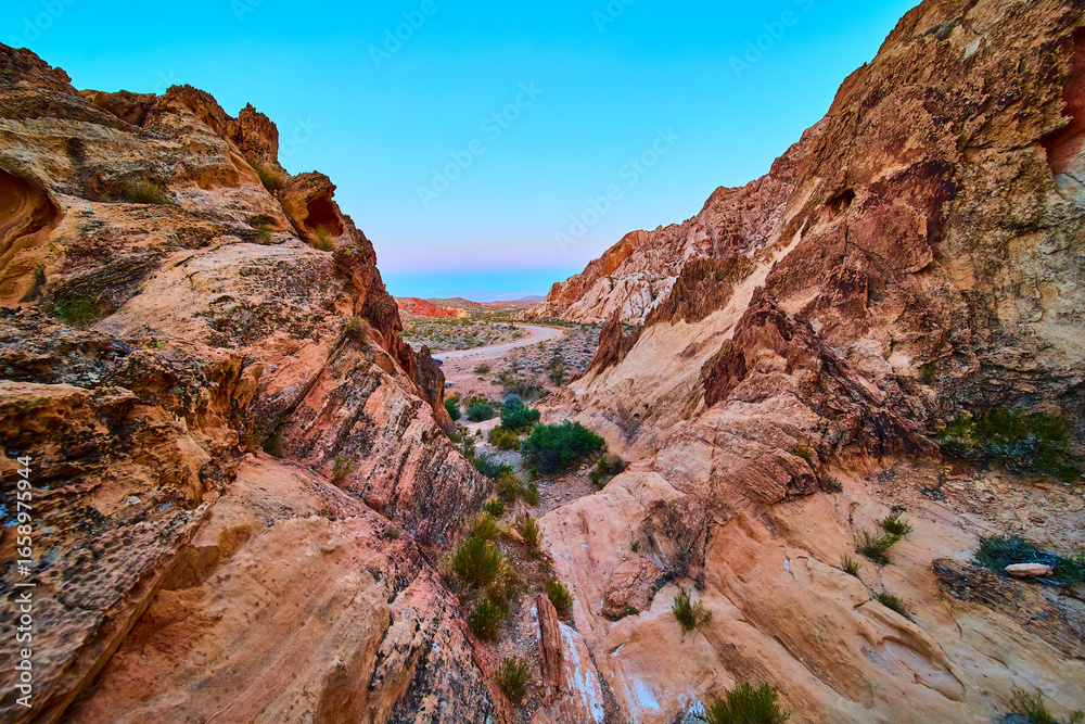 Fototapeta premium Desert Canyon Rocks and Winding Road under Clear Blue Sky