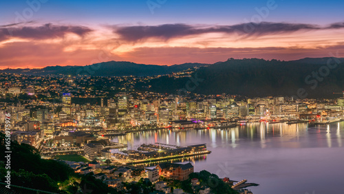 Downtown Wellington city buildings and harbour from Mount Victoria at dusk.