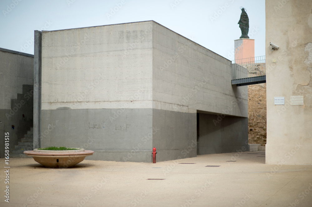 Fototapeta premium modern building in the city near University in Alghero, on top Madonna of Stella Maris on the tower of Sant Elmo, Sardinia, Italy