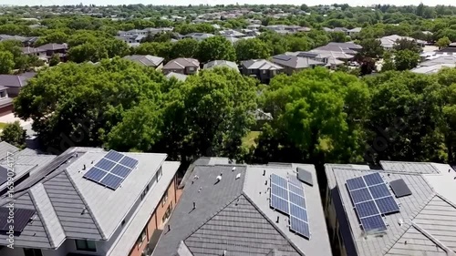 Aerial View of Suburban Neighborhood with Solar Panels on Rooftops Green Trees