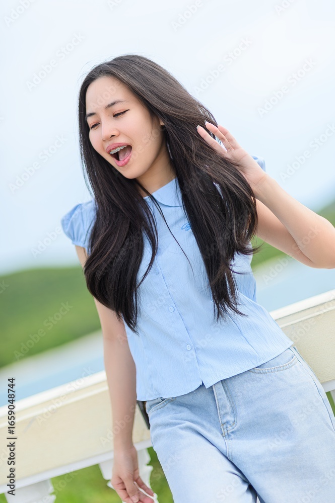 Fototapeta premium Young Woman Enjoying Nature with Long Hair and Casual Outfit