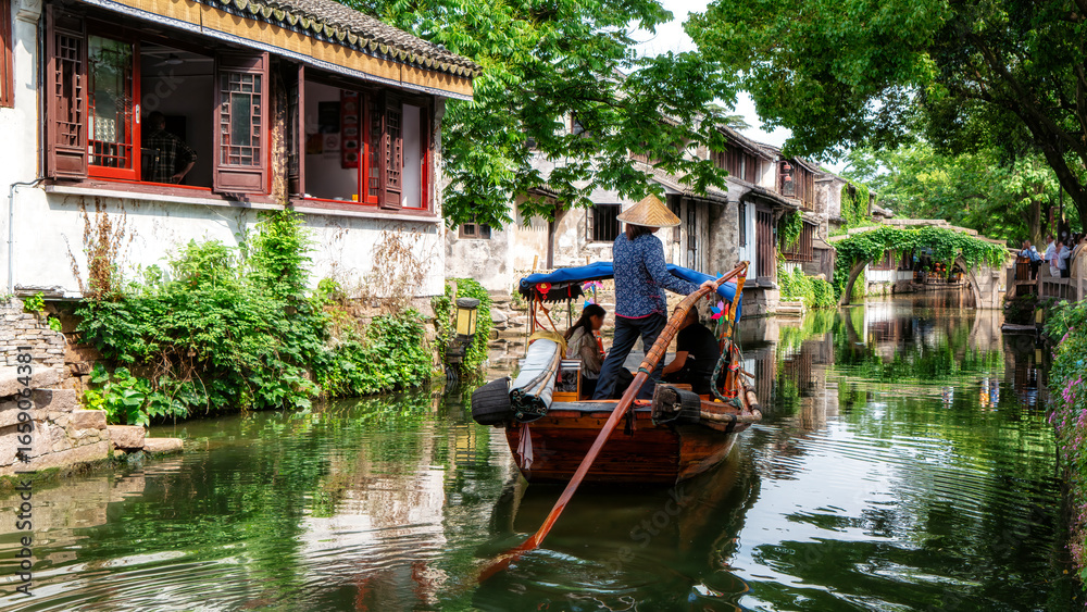 Fototapeta premium Traditional Chinese Boat Tour on Narrow Water Canal