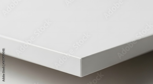 Close-up view of a white, smooth surface with a sharp edge.