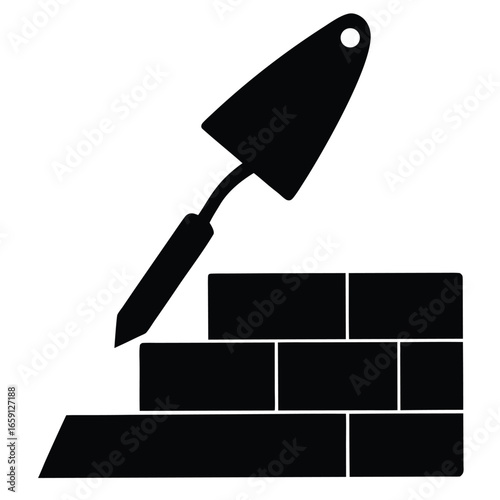 Black vector icon of trowel and bricks