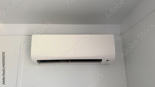 A modern white ductless mini-split air conditioner mounted on a wall