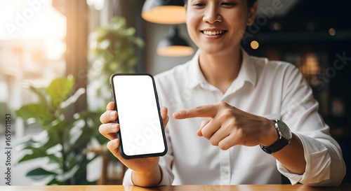 Mockup image of a beautiful woman pointing finger at a mobile phone with blank white screen