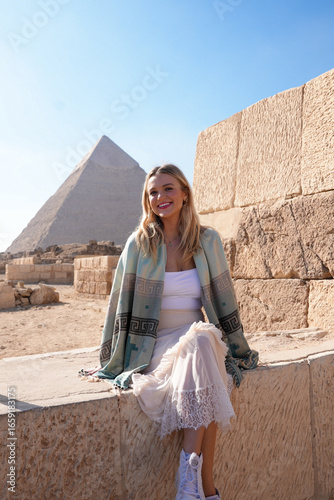 Female Traveler Sitting in Front of Pyramids