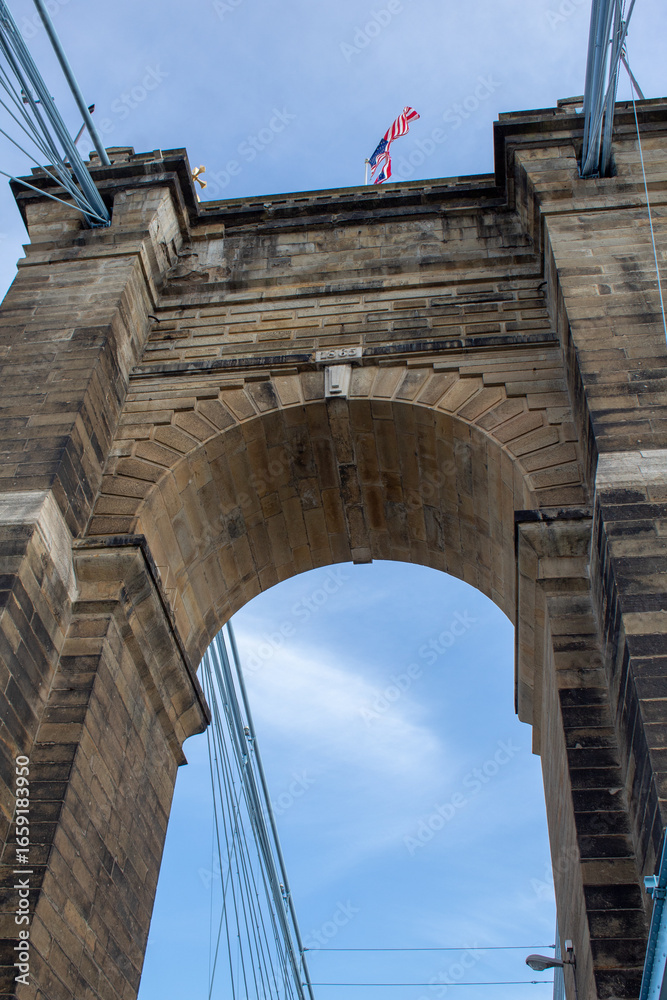 Fototapeta premium One of the arches on the Roebling Suspension Bridge. Tower in need of repair due to sandstone particles falling down.