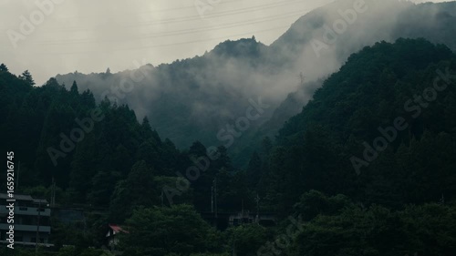Traditional Japanese village set in misty Oku Tama mountain valley with lush greenery – Scenic cinematic shot.