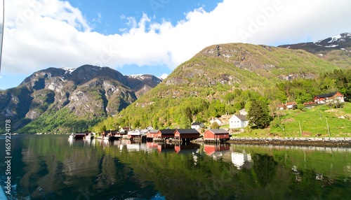 Scenic fjord village reflected in water