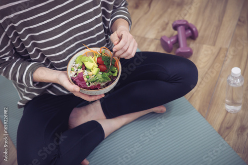 Fresh, nutritious salad held in a person's hands. A balanced meal for a healthy and mindful lifestyle.