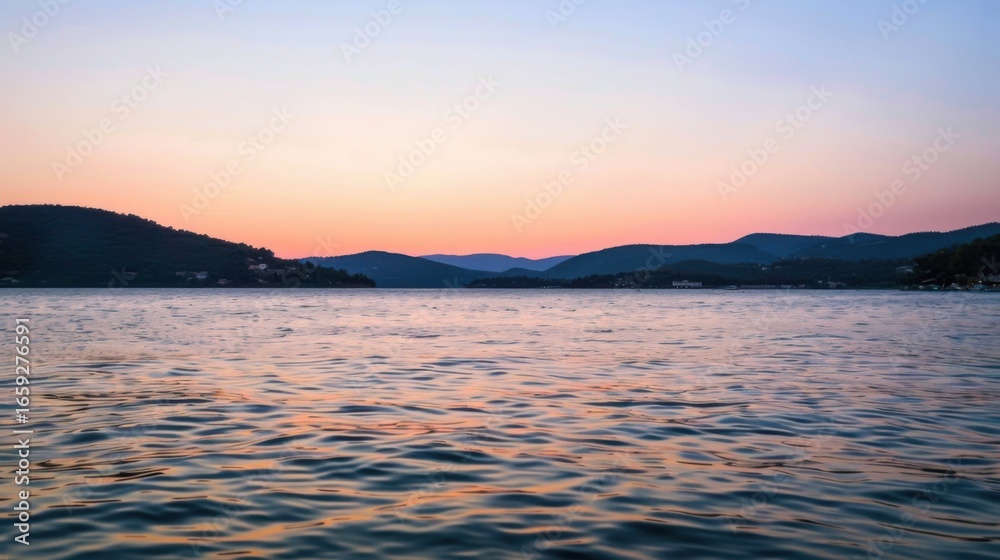 Fototapeta premium Sunset Reflection on a Calm Lake with Distant Hills