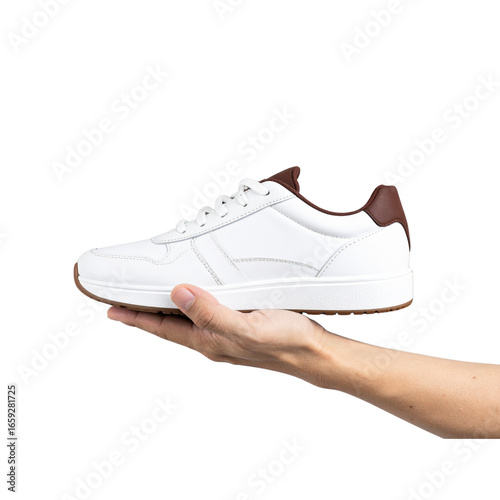  Transparent PNG available Hand holding white sneaker with brown details on transparent background