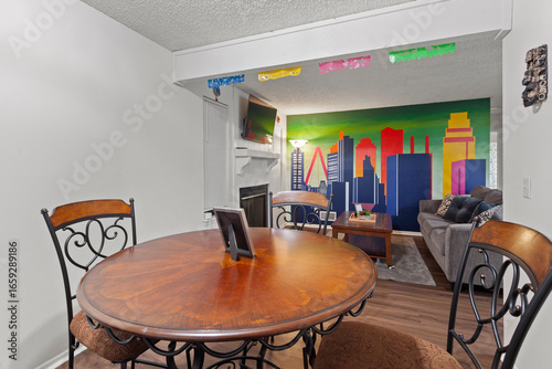 modern dining room. rental. hardwood floors, mural on wall, staged