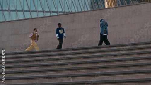 Wallpaper Mural Slow motion wide shot of three gen Z friends having fun while walking around city, dancing, singing and jumping Torontodigital.ca