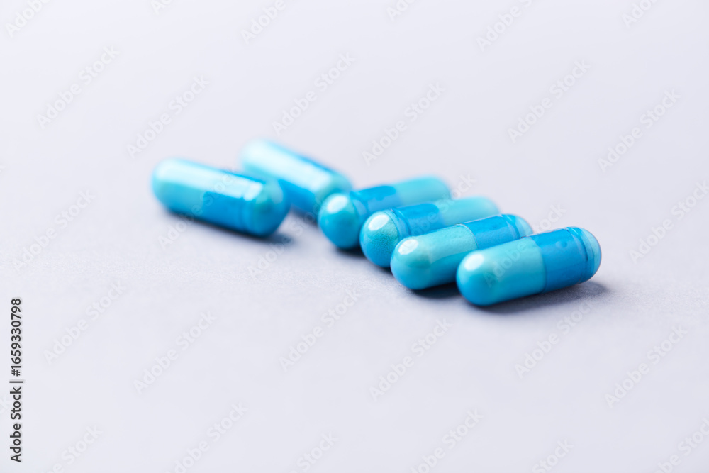 Amino acids capsules on bright background. Soft focus. Close up. Copy space. Amino acids capsules on bright background. Soft focus. Close up. Copy space.