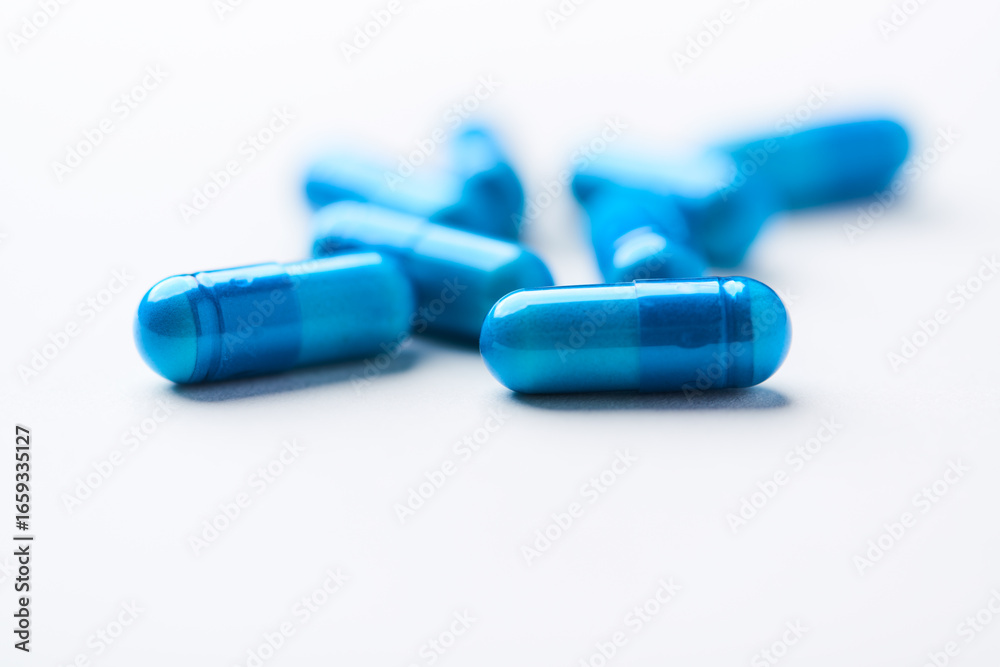Amino acids capsules on bright background. Soft focus. Close up. Copy space. Amino acids capsules on bright background. Soft focus. Close up. Copy space.