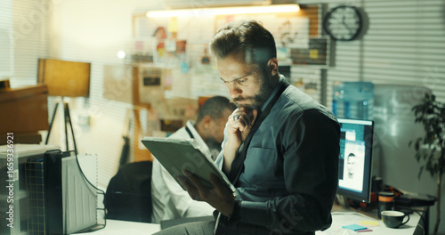 Obraz na płótnie Thinking, detective or man with tablet for investigation, insight or review leads in office at night