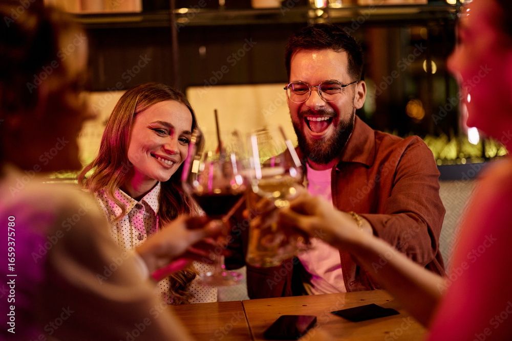Group of Happy Friends Enjoying Drinks Together in a Vibrant Social Setting Group of Happy Friends Enjoying Drinks Together in a Vibrant Social Setting