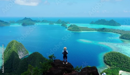 Explorer Admiring Stunning Tropical Islands and Blue Lagoon from a Scenic Viewpoint