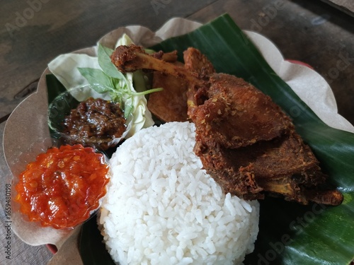The traditional dish penyetan wader and Chicken refers to wader fish that is fried crispy and then crushed with spicy chili sauce, and traditional woven fish as a serving method or garnish. 