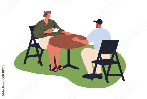 Woman and man sitting at table. Young couple, friends chatting and drinking c...