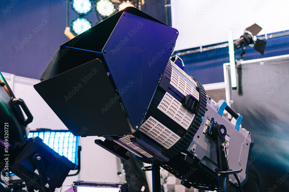 Fototapeta premium Professional studio LED close-up spotlight. Modern equipment for film, television and photo studios. Metal case with cooling, the front part is equipped with light-forming elements.