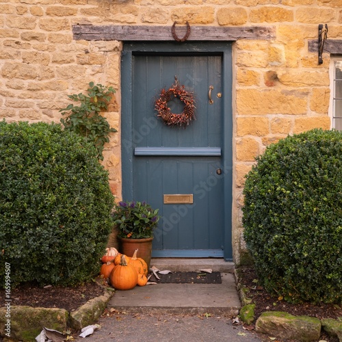 Cotswold cottage door with pumpkins, England