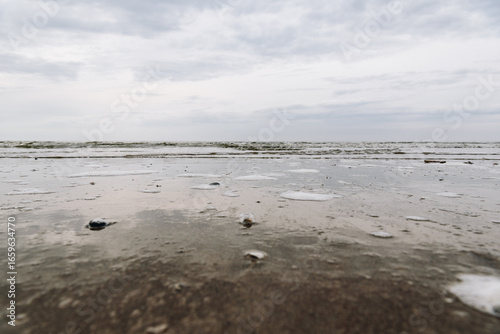 Close-up view of wet sandy beach on the Dutch North Sea coast
