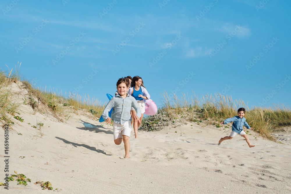 Happy family running at beach on sunny day Happy family running at beach on sunny day
