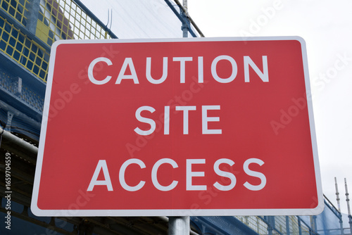 Close Up of Red Metal Road Sign 'Caution Site Access' 