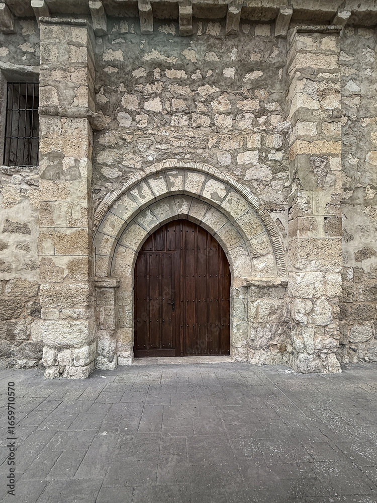 Obraz premium Stone arched entrance of La Asuncion Church in Quintanilla de Trigueros