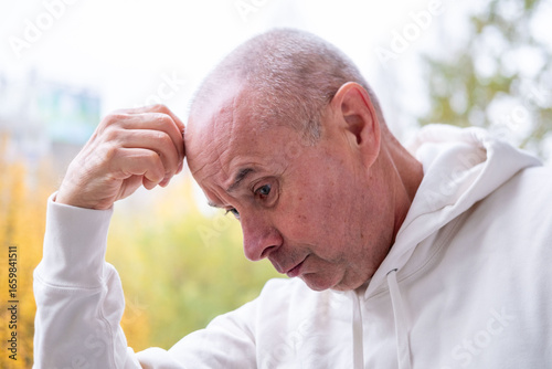 Принти на полотні Concerned unhappy senior man with worried face, troubled expression, thinking de