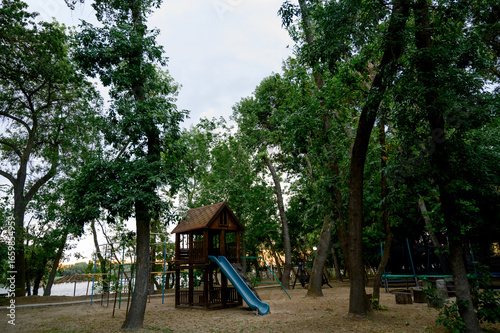 Wallpaper Mural Children's playground with a view of the house and slide in the park Torontodigital.ca